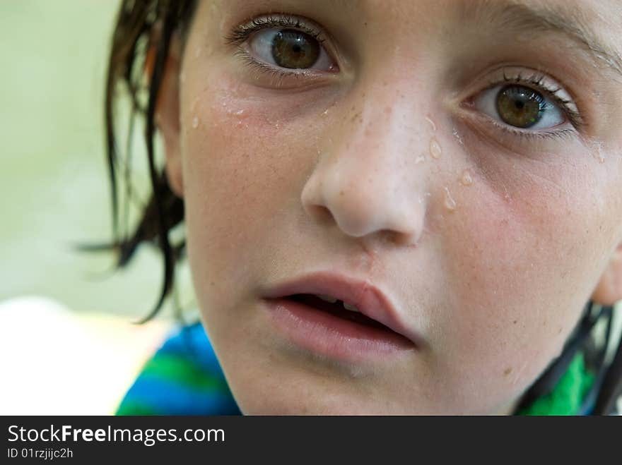 Close up of a wet young girl with an expression of wonderment, interest or curiosity after a bath or swim. Nine years old. Close up of a wet young girl with an expression of wonderment, interest or curiosity after a bath or swim. Nine years old.