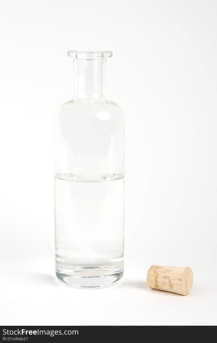 Transparent glass bottle with a cork on a white bakcground. Transparent glass bottle with a cork on a white bakcground.