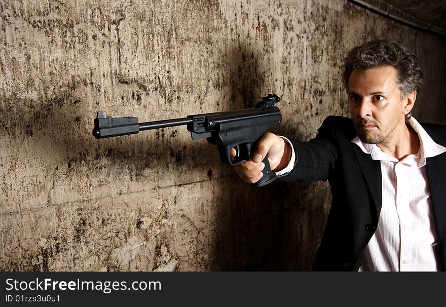 Man killer with gun on dark background