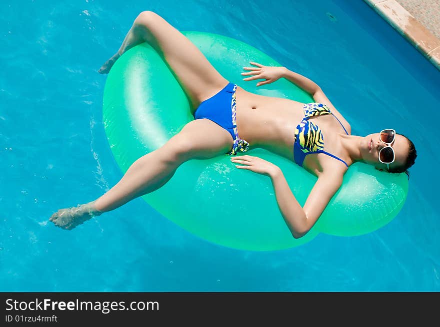 Woman in Inflatable ring in pool