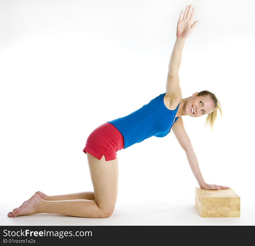 Exercising woman kneeling on the floor