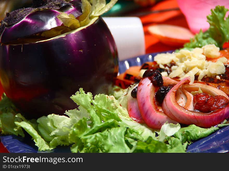 Summer dish consisting of eggplant stuffed with grilled vegetables and crumbs of cheese grana. Summer dish consisting of eggplant stuffed with grilled vegetables and crumbs of cheese grana