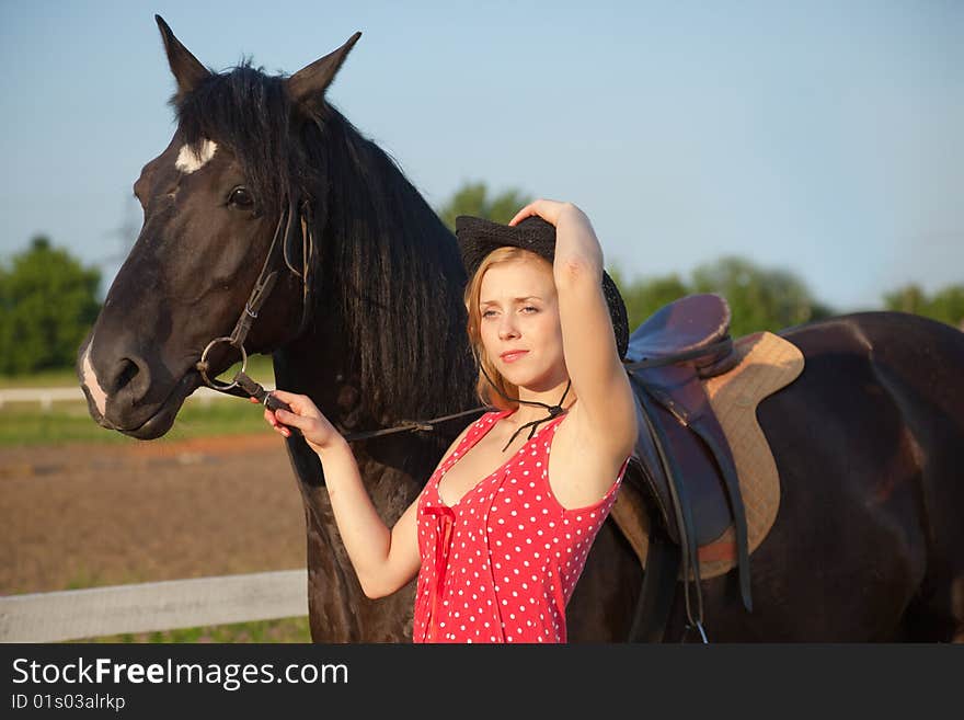 Young blond woman with horse