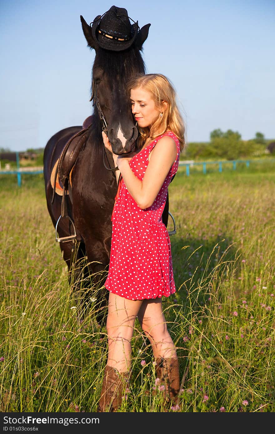 Young blond woman in red dress with horse. Young blond woman in red dress with horse