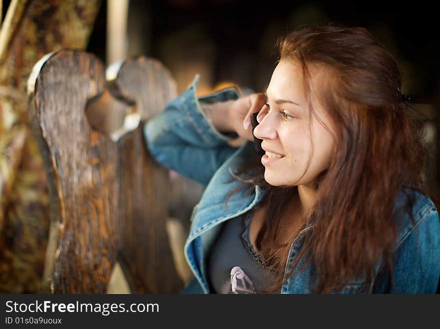 Young lady is calling by mobile phone