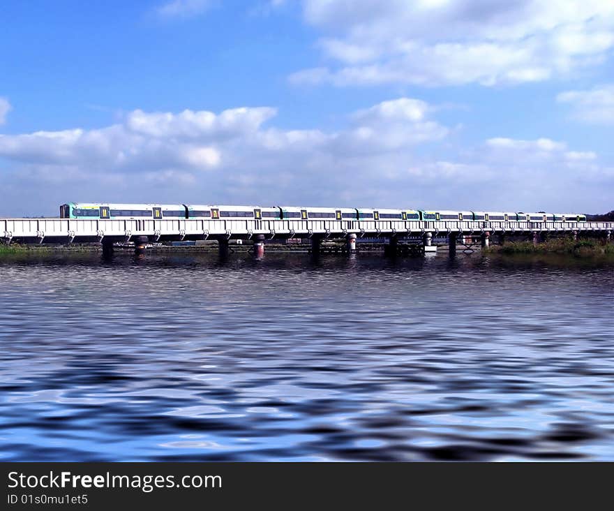 Landscape of commuter train crossing a river