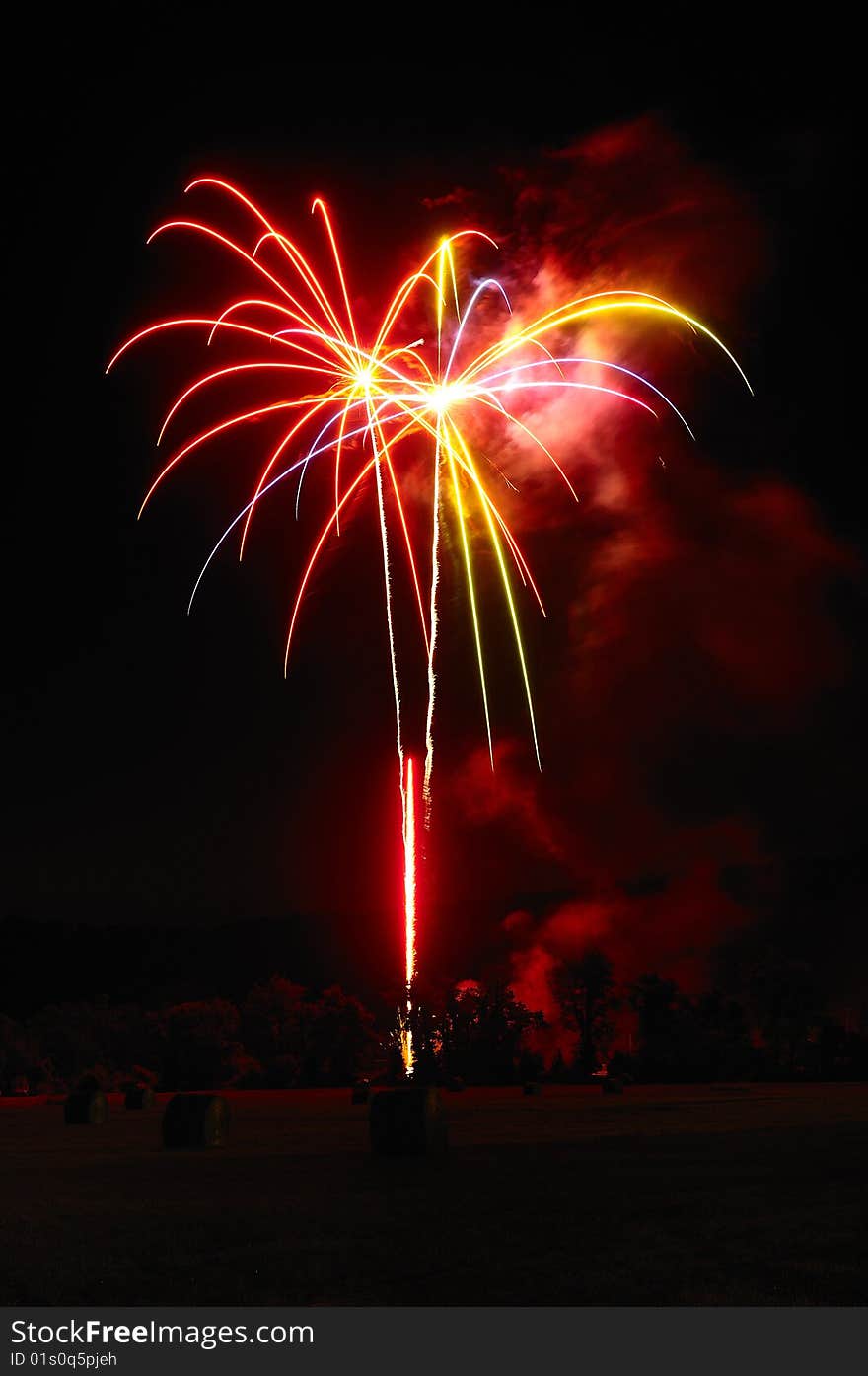 Fireworks exploding over hay field. Fireworks exploding over hay field