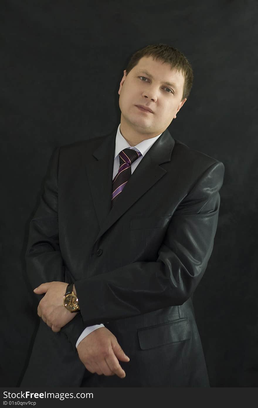 Closeup portrait of  handsome businessman over black background