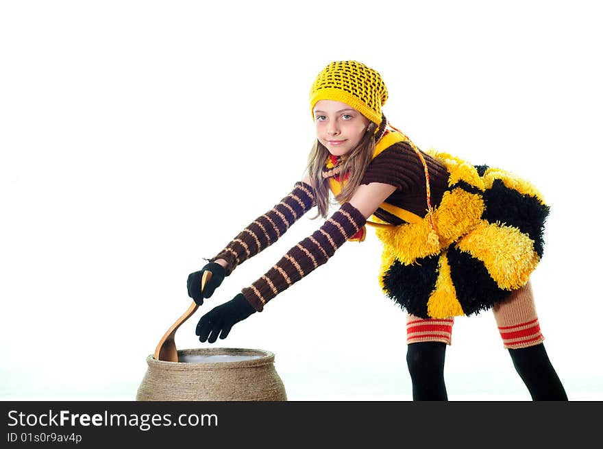 The little girl in a costume cooks food. The little girl in a costume cooks food