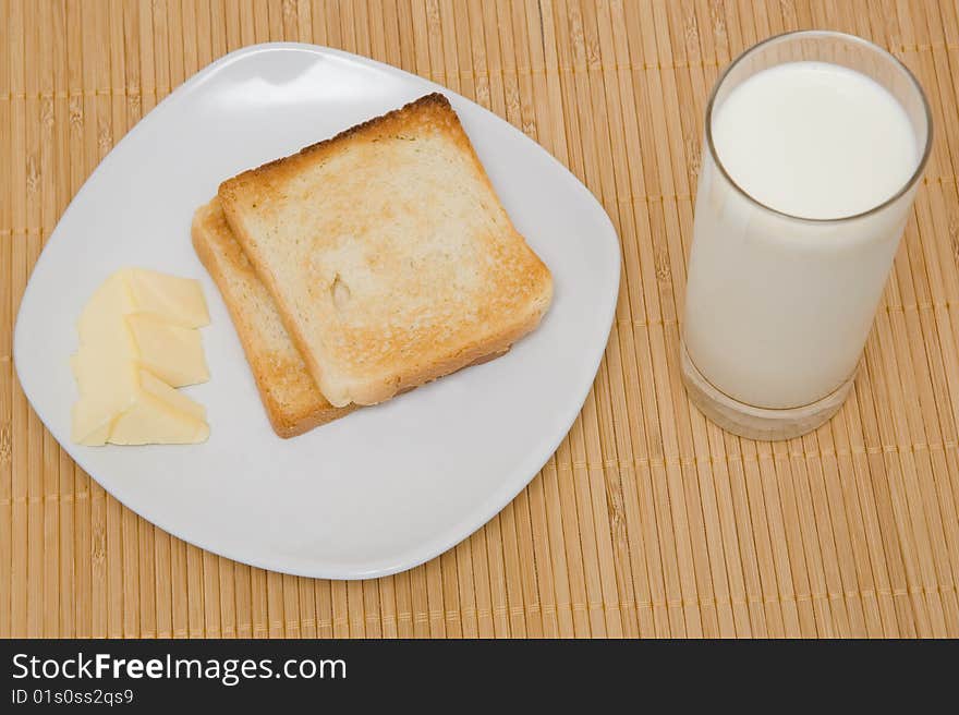 Toasts and butter on a bamboo mat