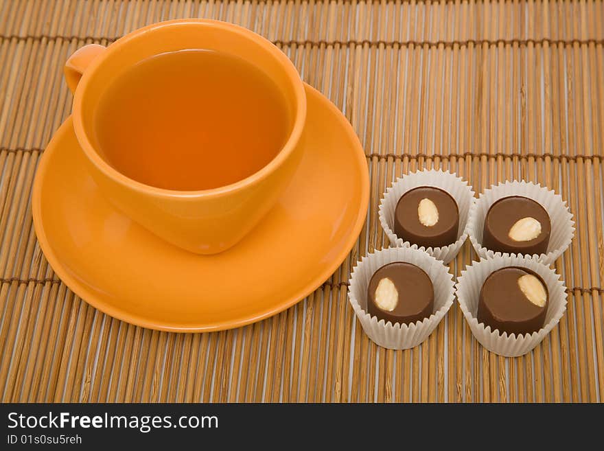 Cup of tea and four chocolate sweets