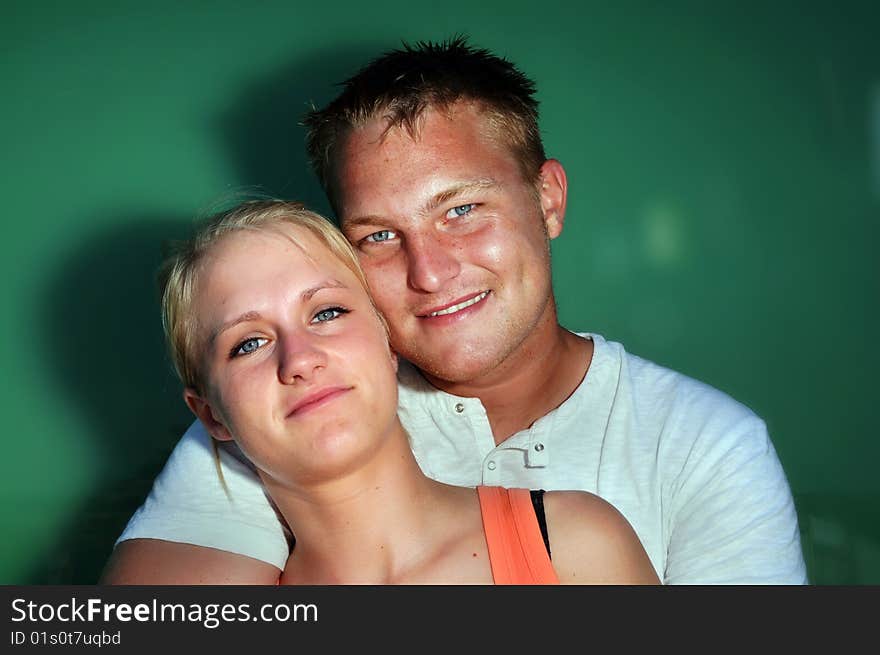 Young man hugging young woman. Young man hugging young woman