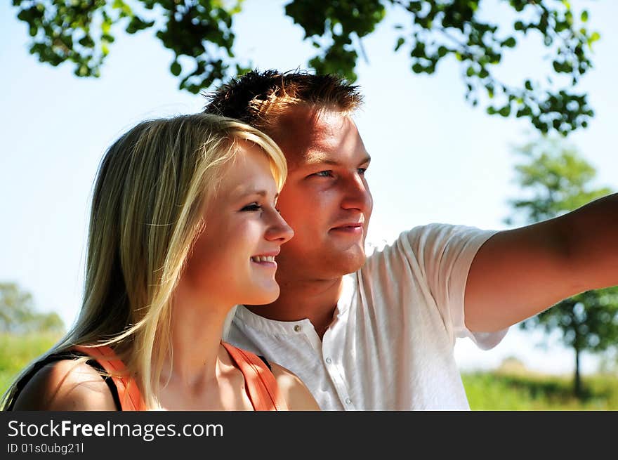 Young couple in the shadow - man pointing