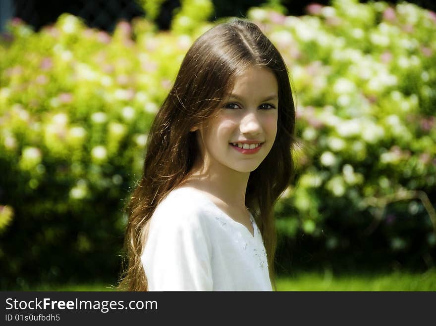 Portrait of pretty girl in garden smile and look at camera. Portrait of pretty girl in garden smile and look at camera