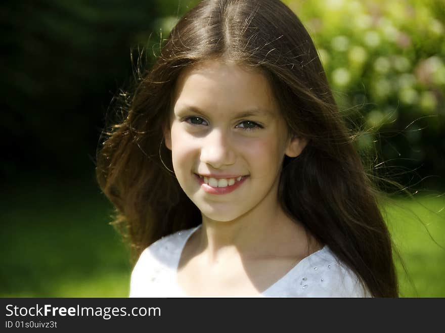 Close up face of pretty girl in garden who looking and smiling to camera. Close up face of pretty girl in garden who looking and smiling to camera