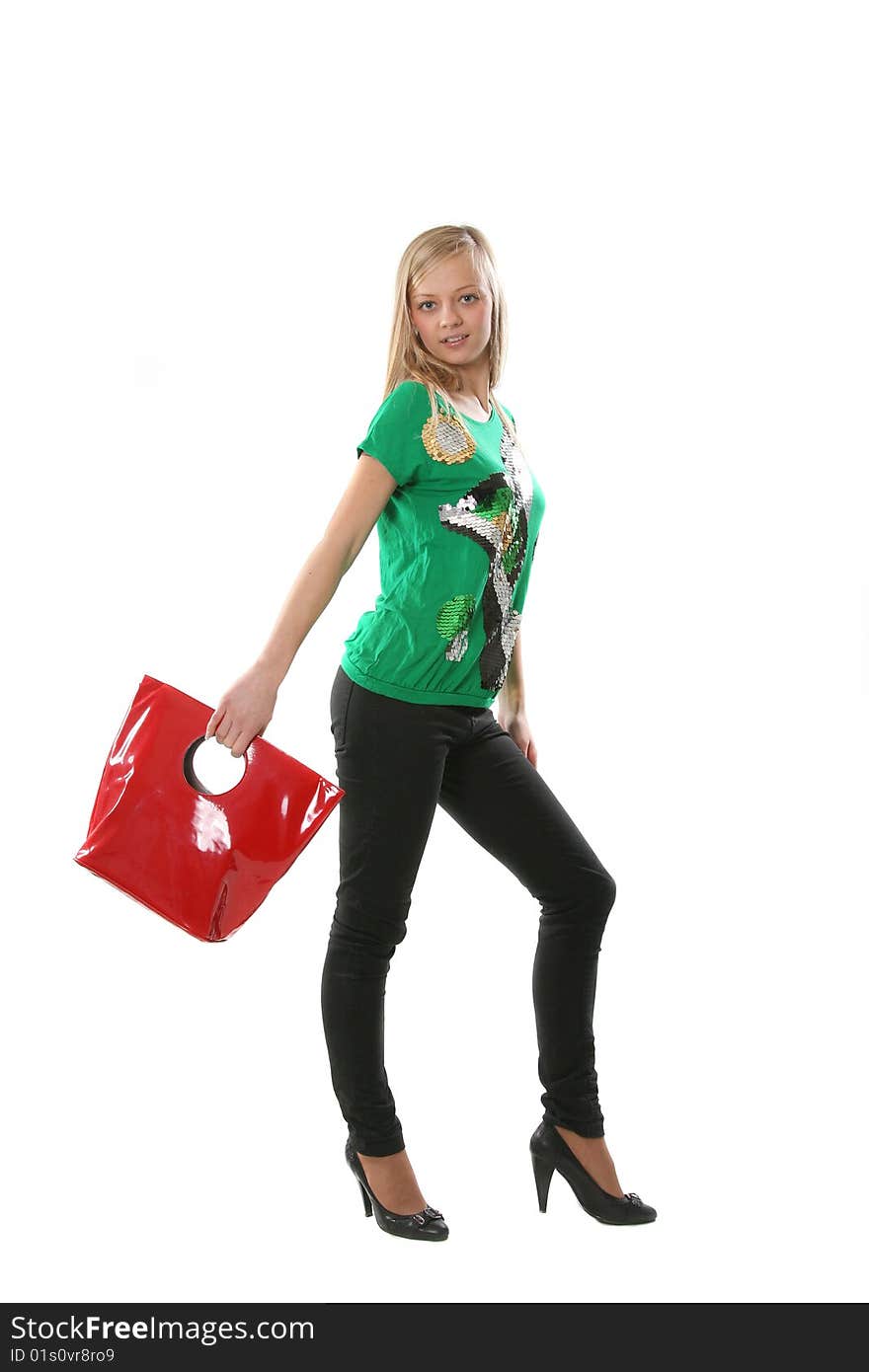 The beautiful girl with purchases from shop in a red bag