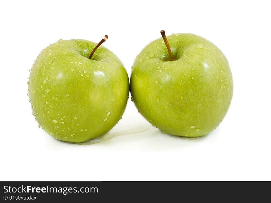 Two green apples with droplets on a white background