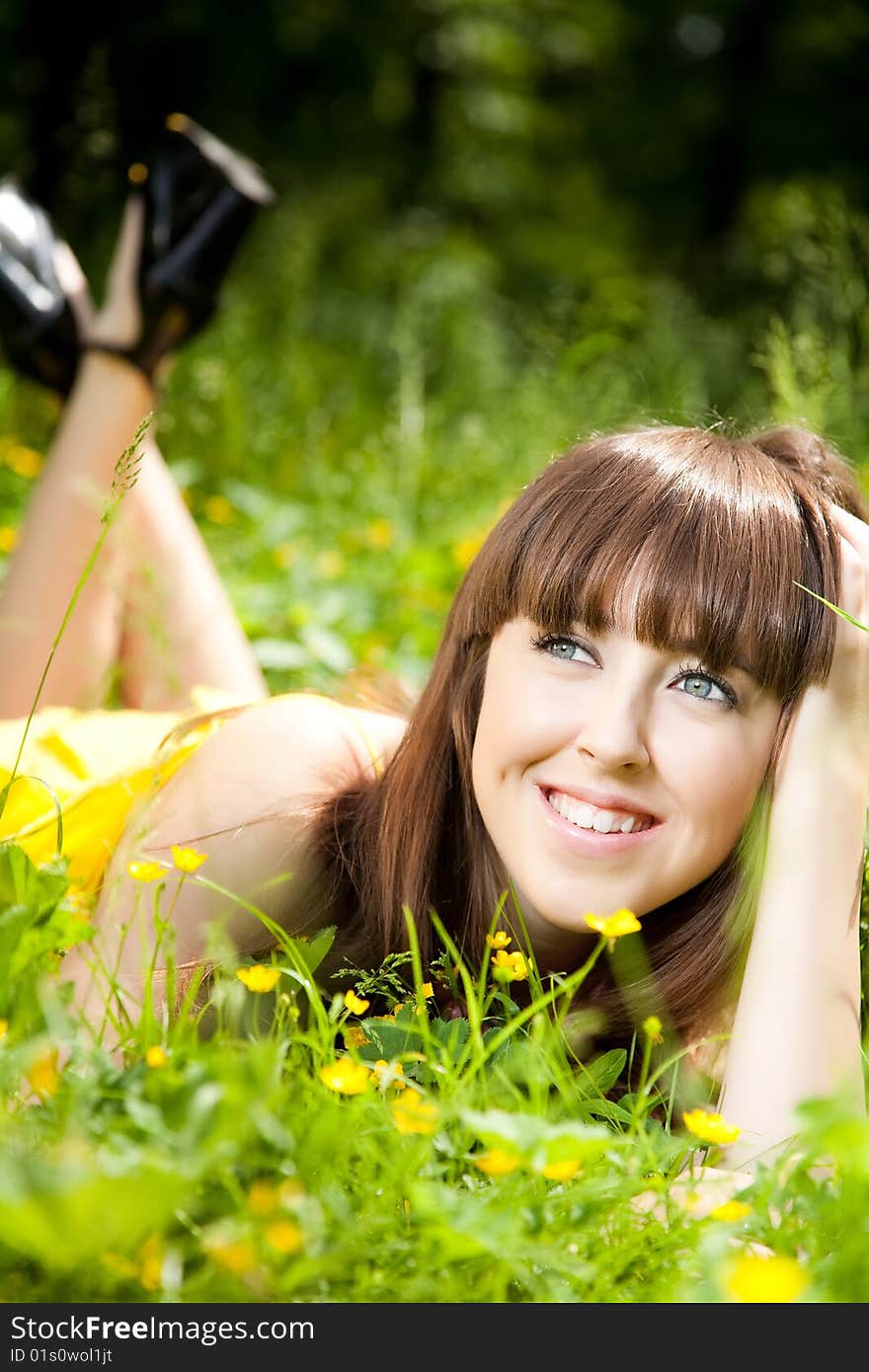 Beauty young woman relaxing in the grass