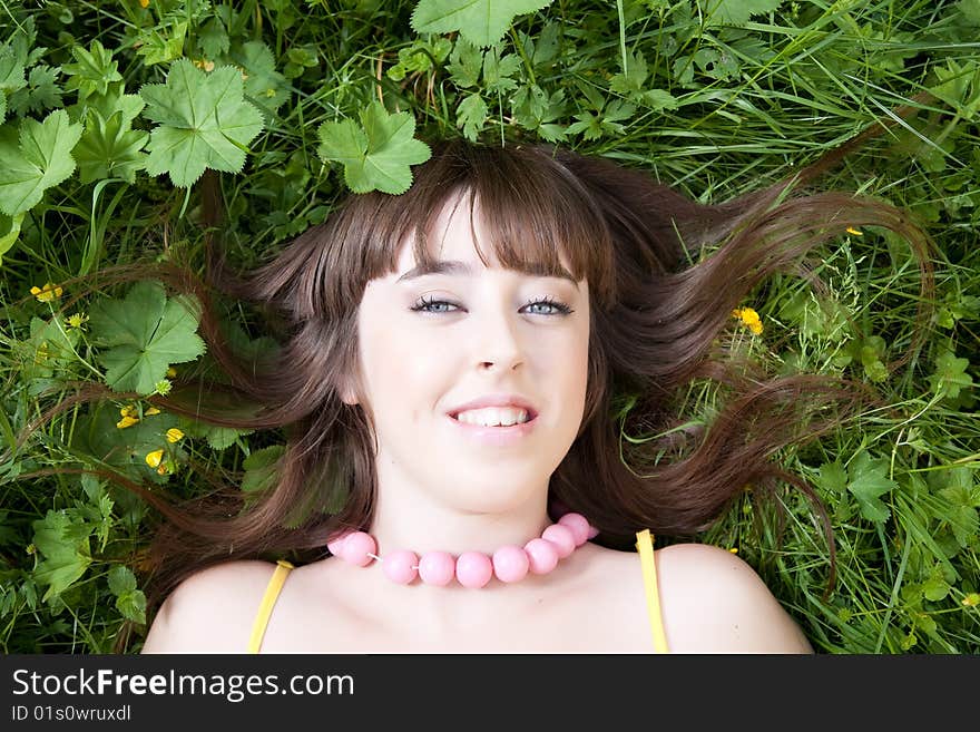 Smiling pretty girl relaxing on the meadow. Smiling pretty girl relaxing on the meadow