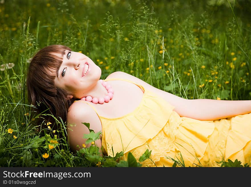 Young beautiful woman lays on green field. Young beautiful woman lays on green field