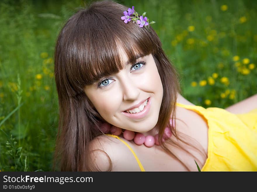 Smiling pretty girl relaxing on the meadow. Smiling pretty girl relaxing on the meadow