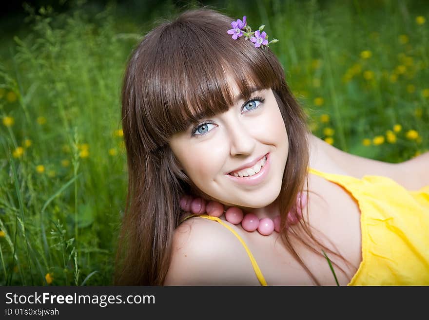 Pretty young smiling girl relaxing outdoor