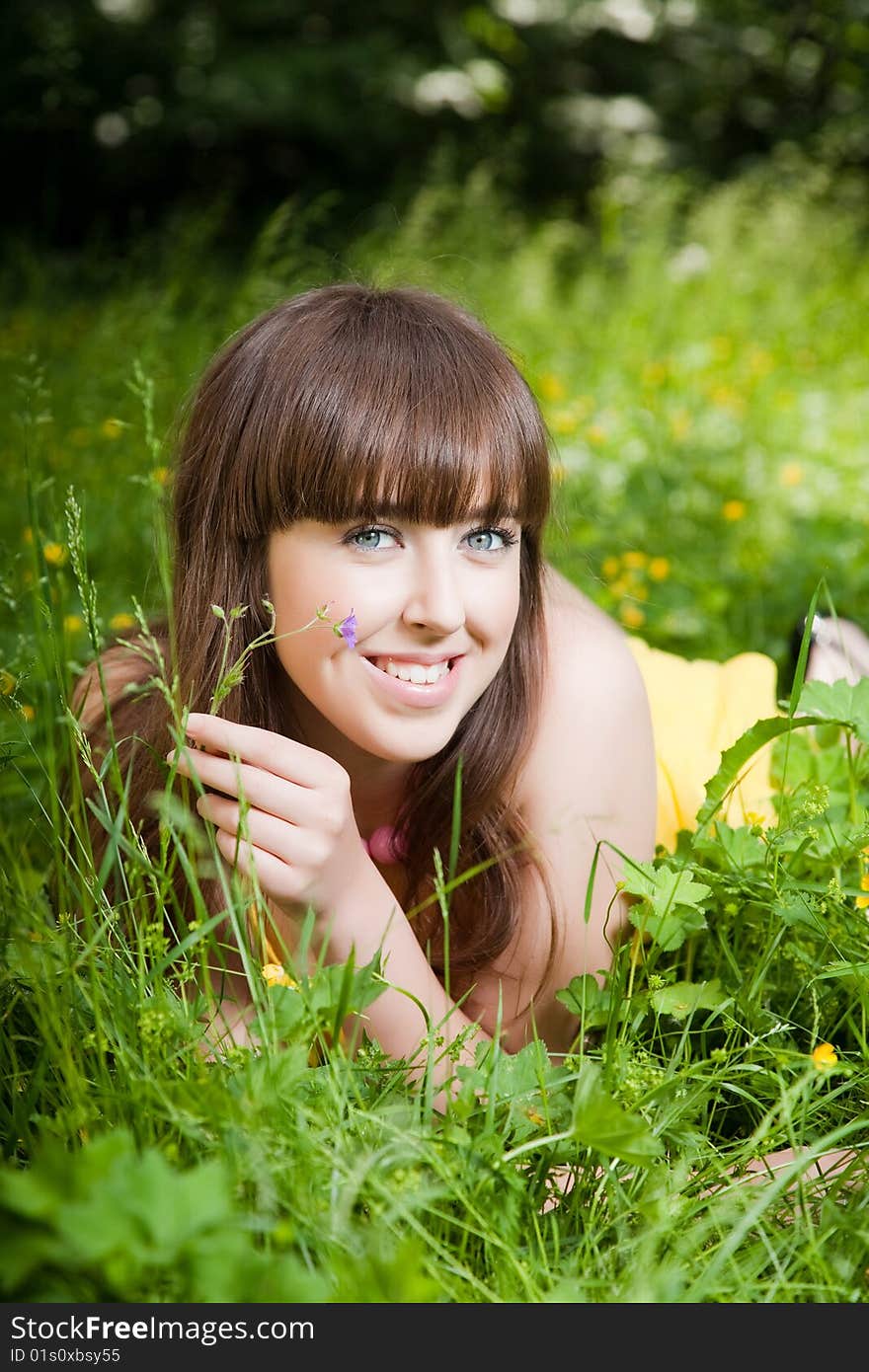 Beauty young woman relaxing in the grass