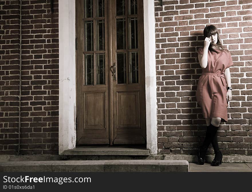 Beauty Woman Standing Against Old Brick Building