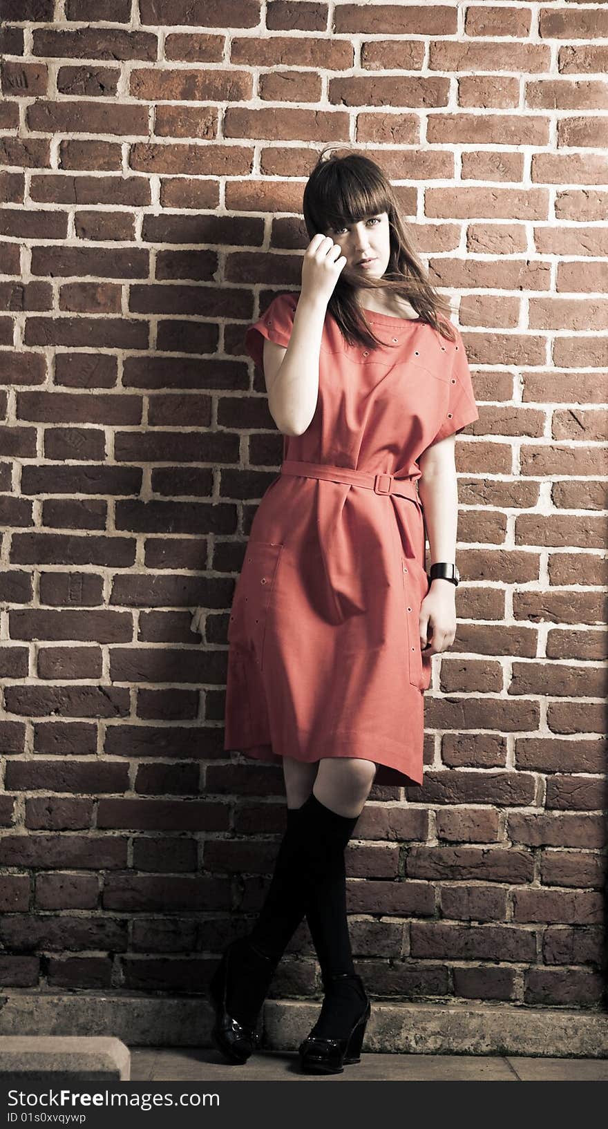 Beauty Woman Standing Against Brick Wall. Beauty Woman Standing Against Brick Wall