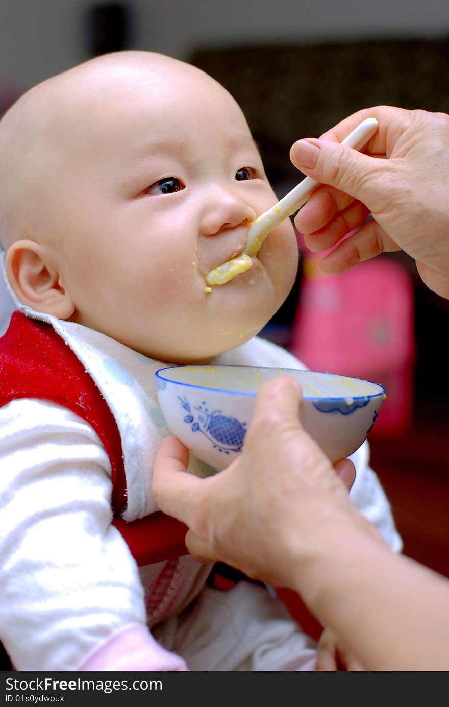 Baby with a spoon in a mouth. Baby with a spoon in a mouth