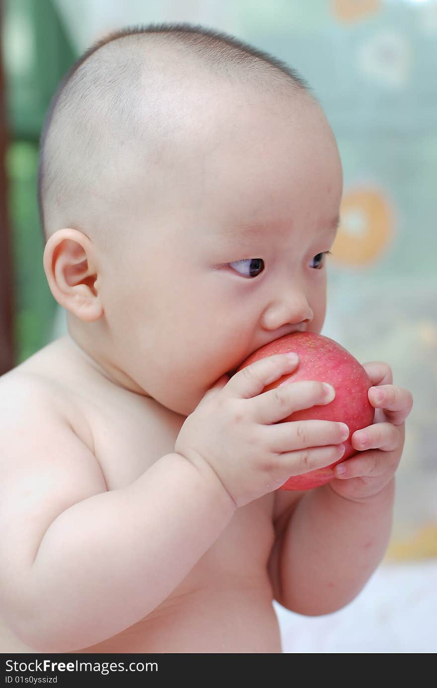 Cute baby boy open his mouth to eat red apple. Cute baby boy open his mouth to eat red apple