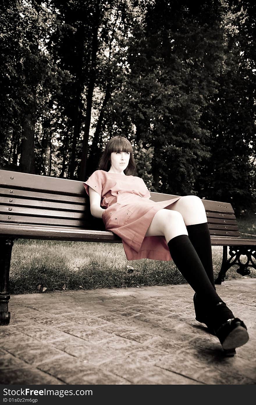 Pretty Woman Sitting On A Bench