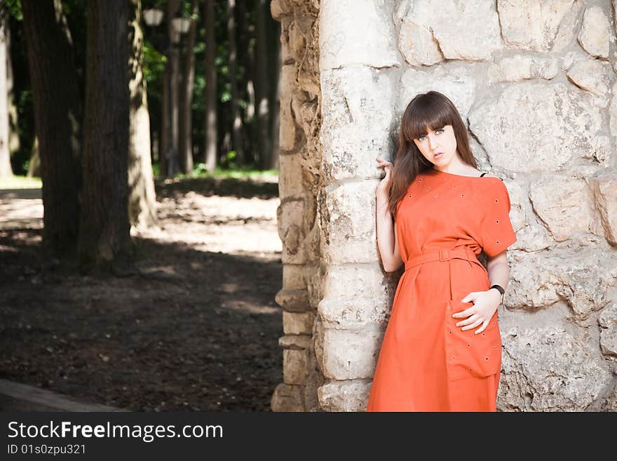 Beauty Woman against Stone Wall At The Park. Beauty Woman against Stone Wall At The Park