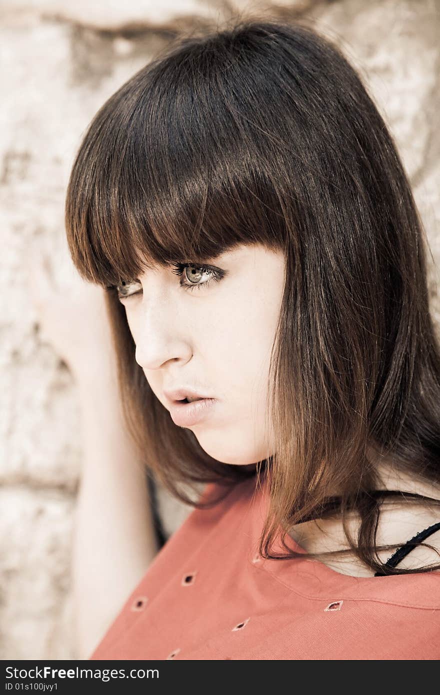 Portrait of thinking woman against stone wall. Portrait of thinking woman against stone wall