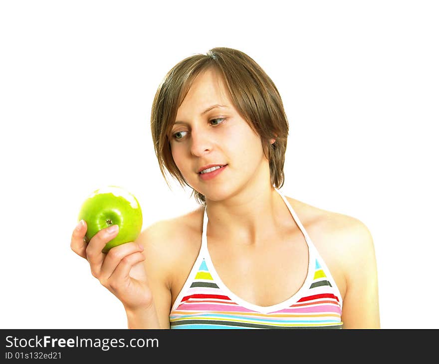 Portrait of an attractive Caucasian blond girl with a nice colorful striped dress who is smiling and she is holding a bitten fresh green apple in her hand. Isolated on white. Portrait of an attractive Caucasian blond girl with a nice colorful striped dress who is smiling and she is holding a bitten fresh green apple in her hand. Isolated on white.