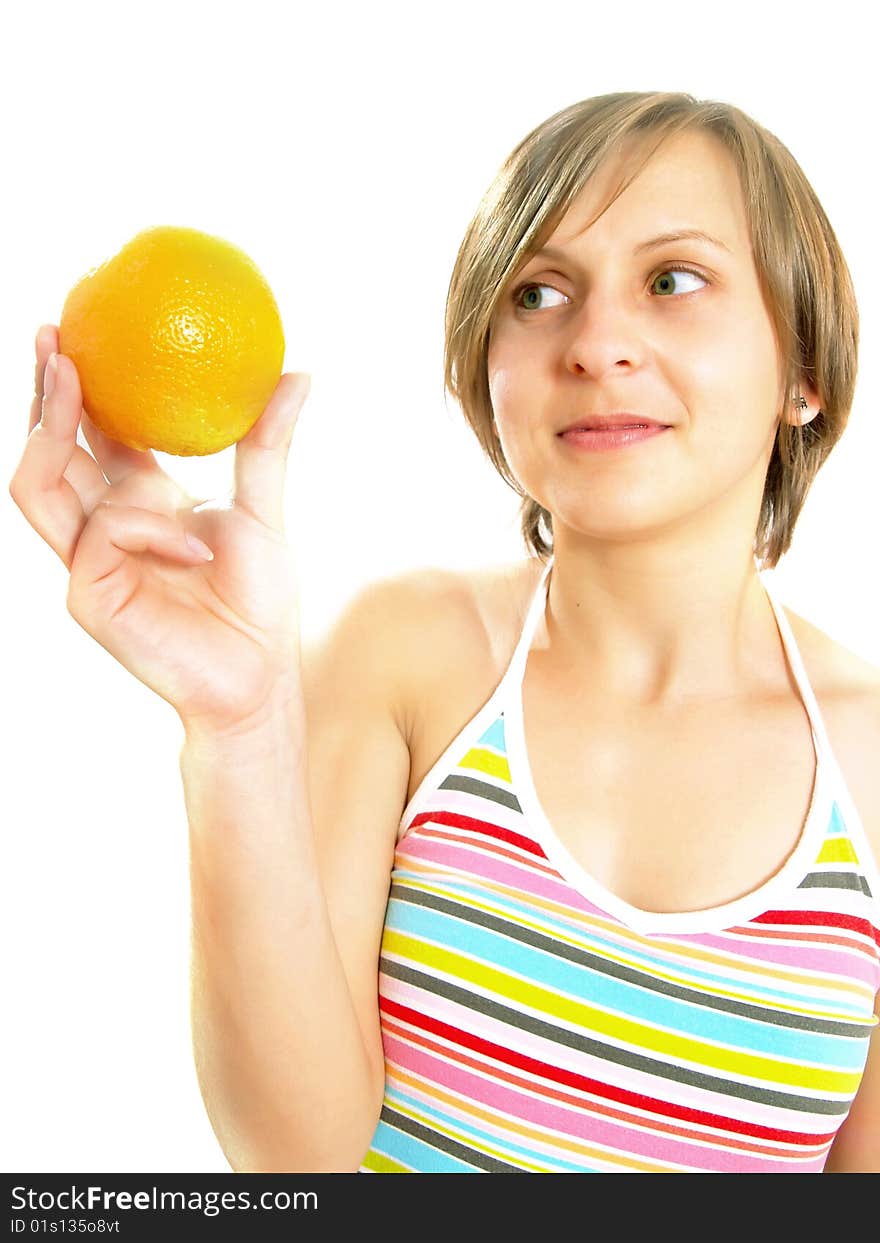 Portrait of an attractive Caucasian blond girl with a nice colorful striped dress who is smiling and she is holding a fresh orange in her hand. Isolated on white. Portrait of an attractive Caucasian blond girl with a nice colorful striped dress who is smiling and she is holding a fresh orange in her hand. Isolated on white.