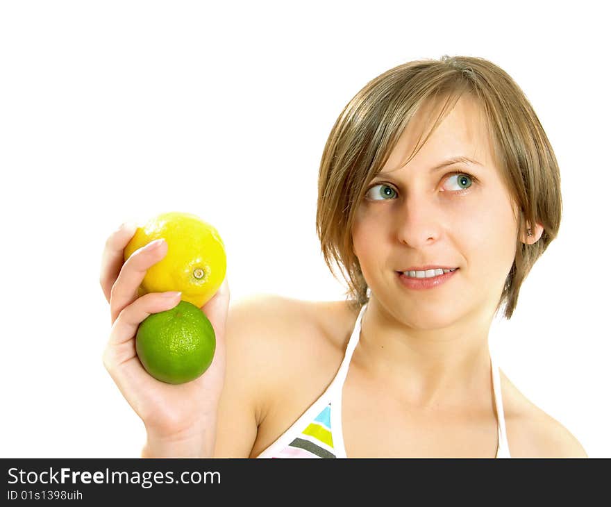 Portrait of a cute young Caucasian blond lady with a nice colorful striped summer dress who is smiling and she is holding a fresh lemon and a lime in her hand. Isolated on white. Portrait of a cute young Caucasian blond lady with a nice colorful striped summer dress who is smiling and she is holding a fresh lemon and a lime in her hand. Isolated on white.