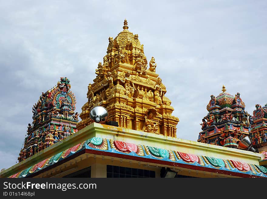 Indian god temple with alot of deities carving on top. Indian god temple with alot of deities carving on top