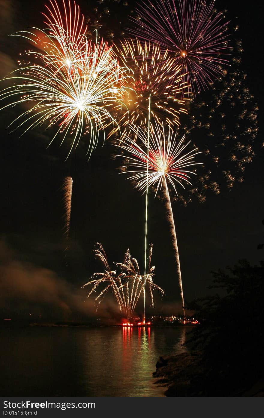 Fireworks display reflected over the waters of Long Island Sound. Fireworks display reflected over the waters of Long Island Sound.