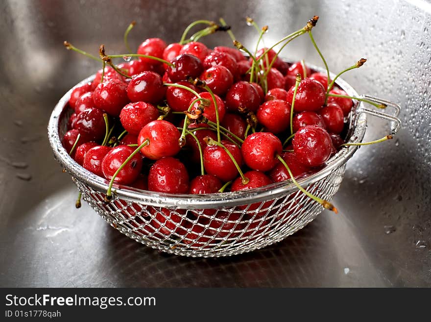 Wet fresh cherry in the kitchen sink. Wet fresh cherry in the kitchen sink