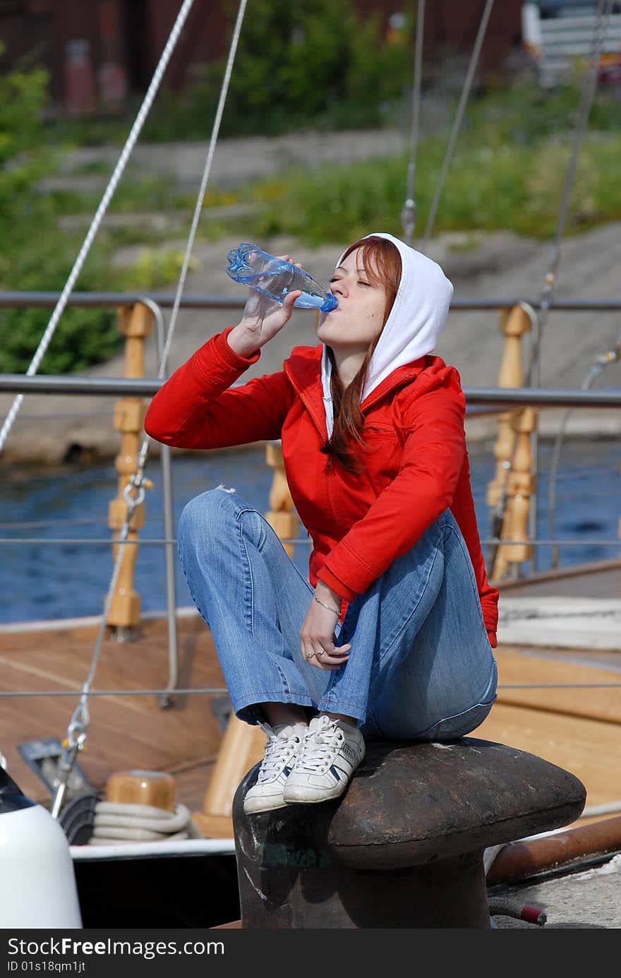 Woman sit on the coast and drinking water. Woman sit on the coast and drinking water