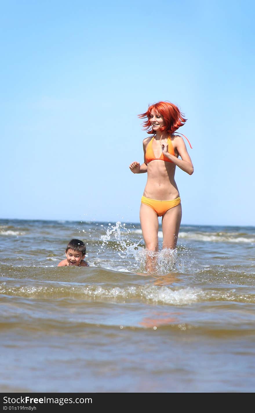 Young mother and son having fun on the beach. Young mother and son having fun on the beach