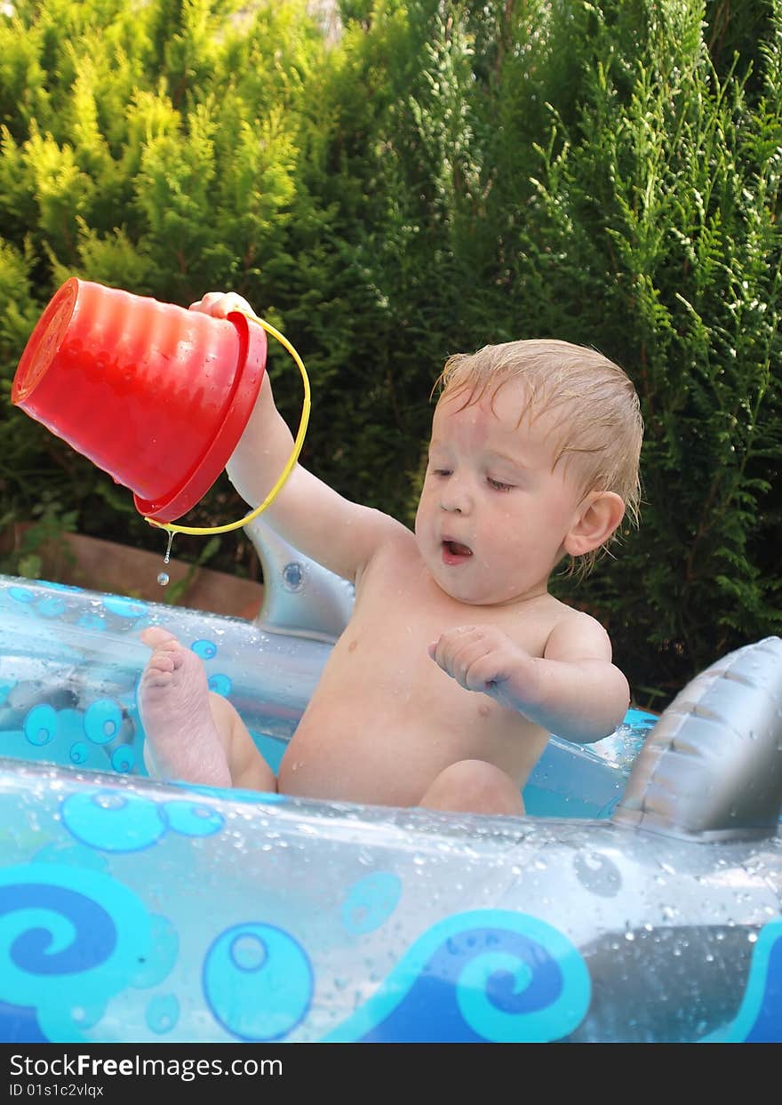 A small boy plays in the childs pool