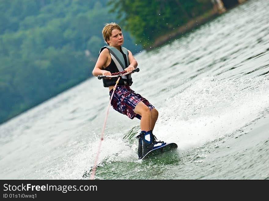 This young boy is 9 years old and he's having fun on his wakeboard. This young boy is 9 years old and he's having fun on his wakeboard.