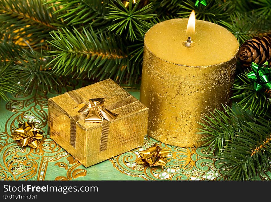 Gold festive candle and present with tree