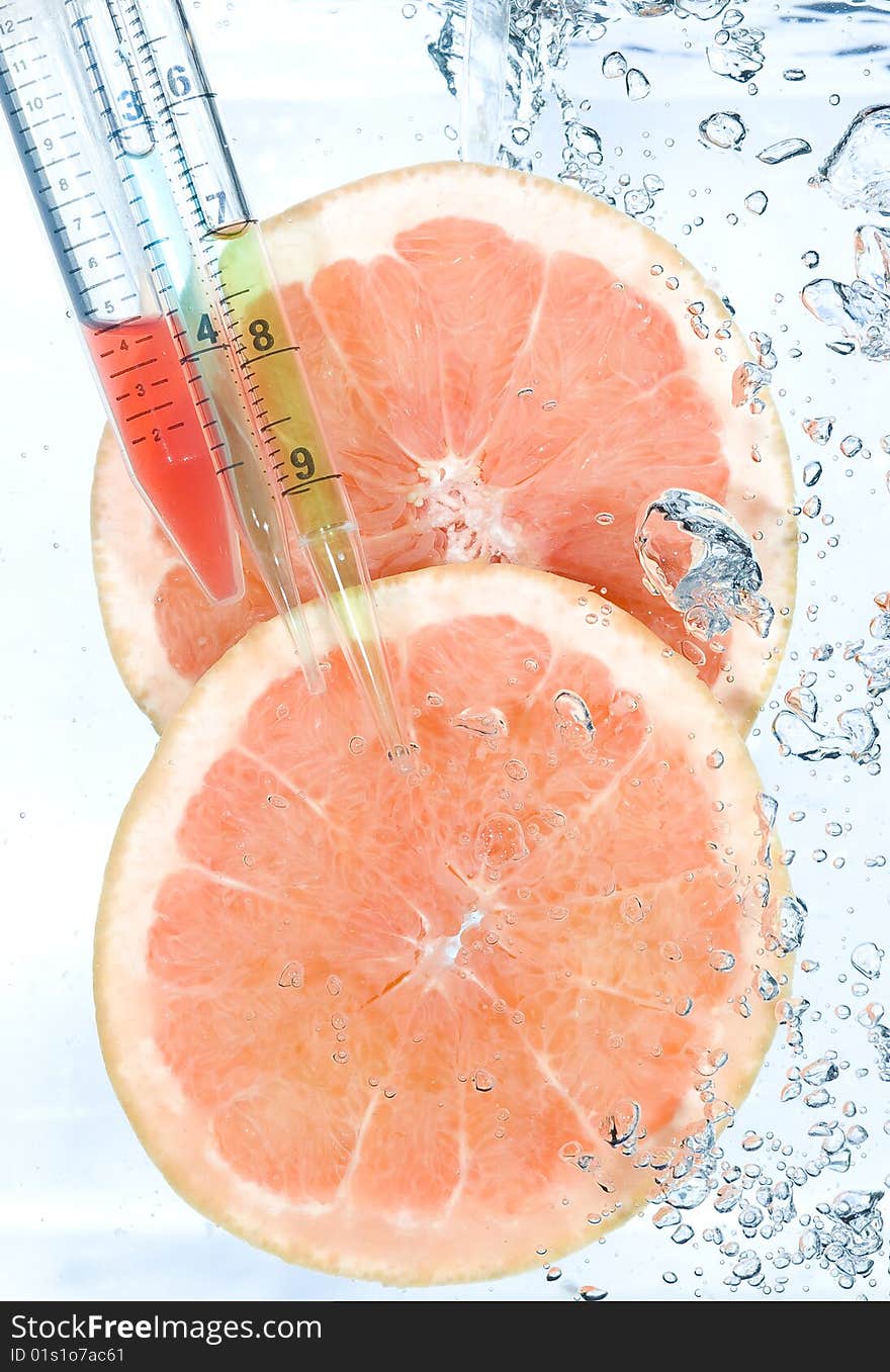 Red grapefruit in water. Creative fruit and bubbles water