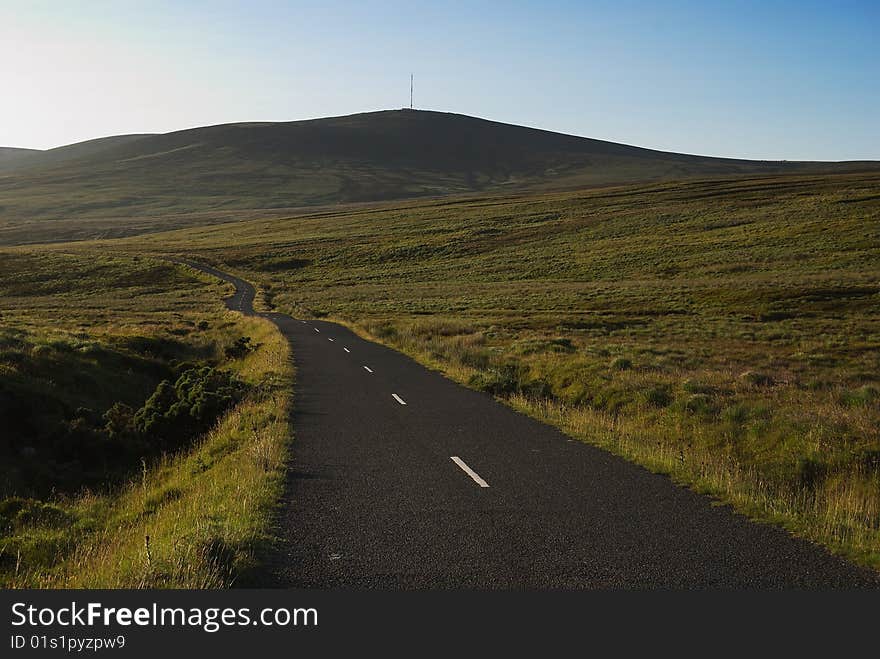 Narrow mountain road in Wicklow before sunset (Ireland)