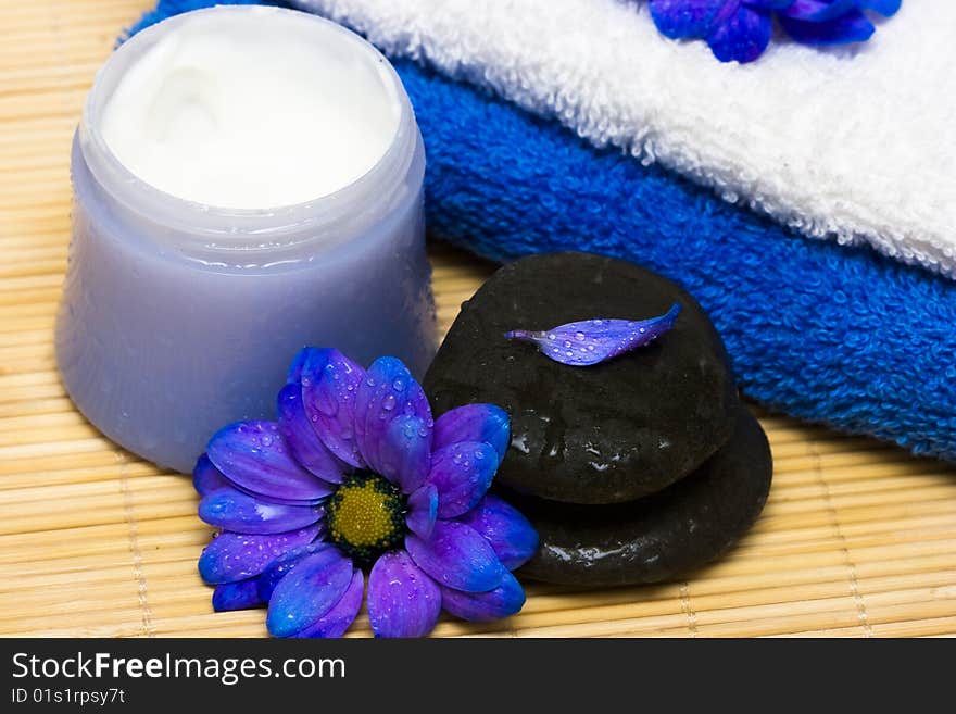 Cream, stones and towel with flowers