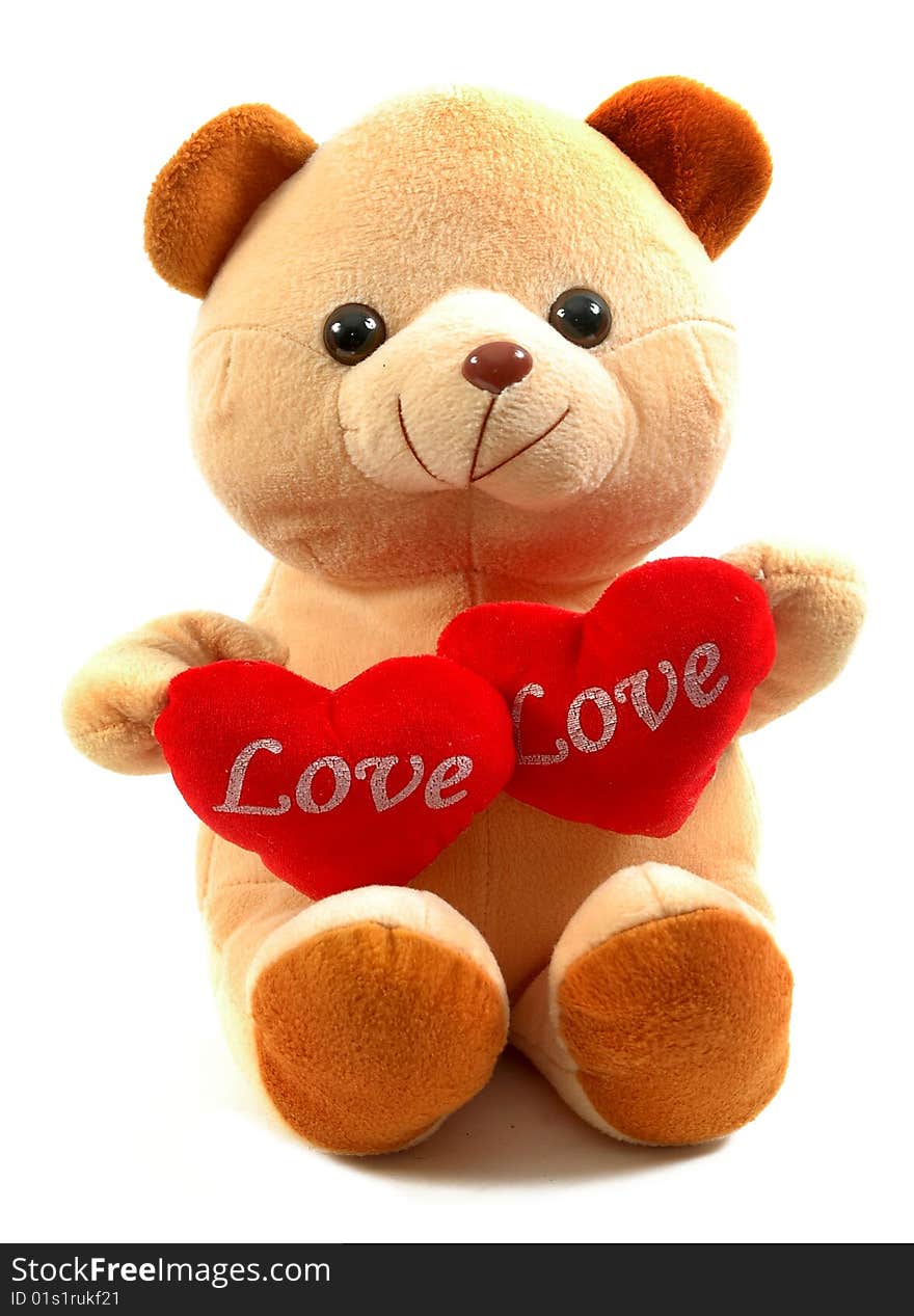 Teddy bear holding two hearts, isolated on white background.