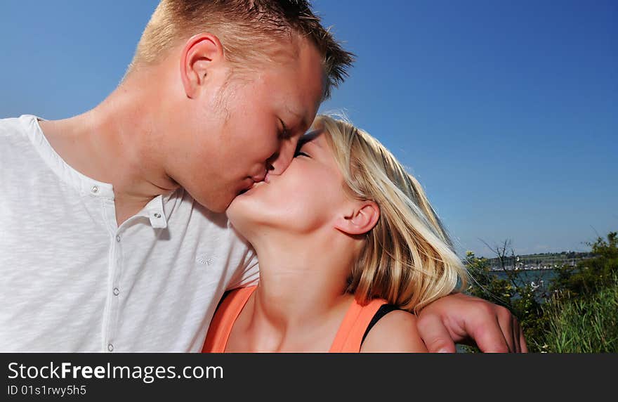 Young couple kissing in the sun. Young couple kissing in the sun